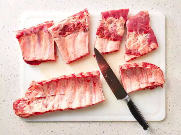 Ribs placed on a cutting board with a knife nearby