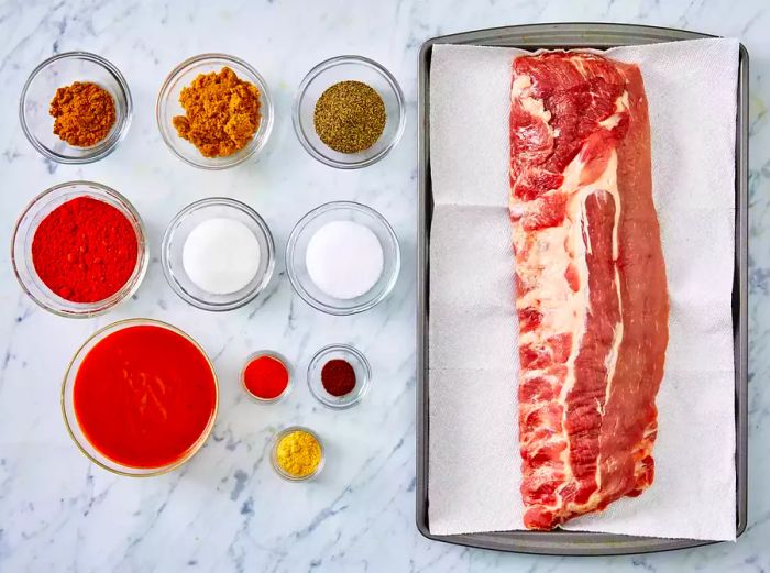 Arrange all ingredients in separate bowls and place the rack of ribs on a baking sheet.