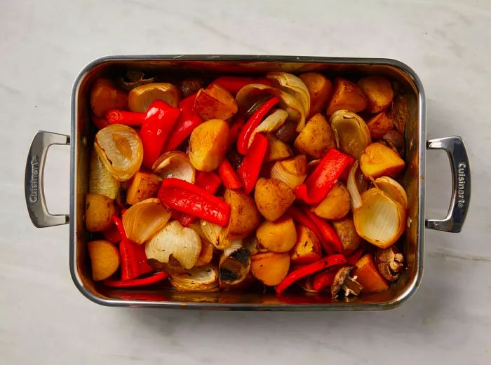 Overhead view of a roasting pan with chunks of cooked vegetables