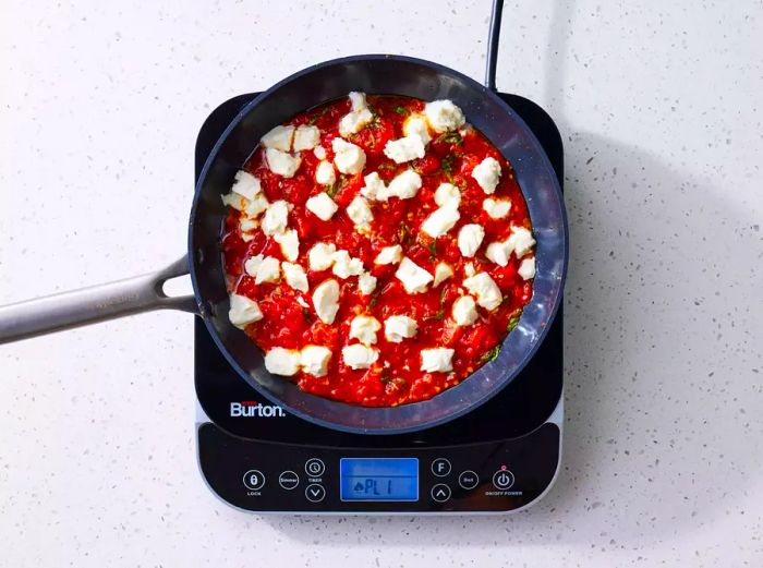 Ricotta Gnocchi with sauce simmering in a pan on the stove