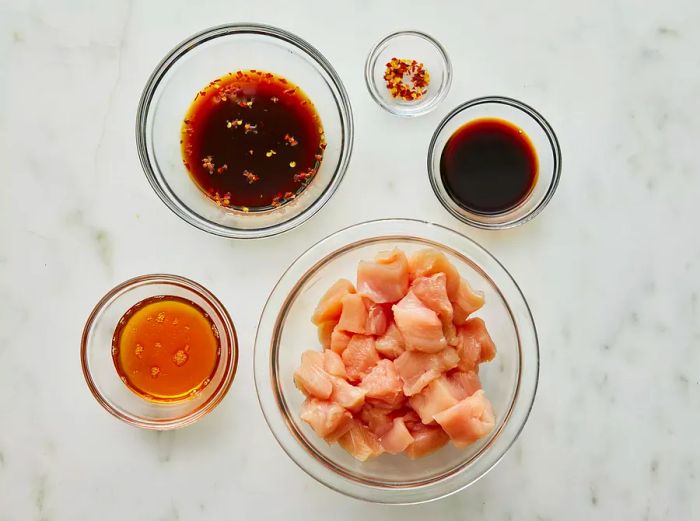 Bird's eye view of the ingredients measured out for honey-glazed chicken