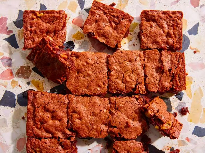 An up-close, overhead shot of brownies that have cooled and been neatly sliced into squares.