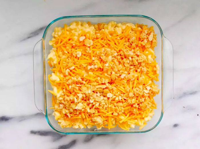 A high-angle shot of a baking dish filled with macaroni and cheese, ready to go into the oven.