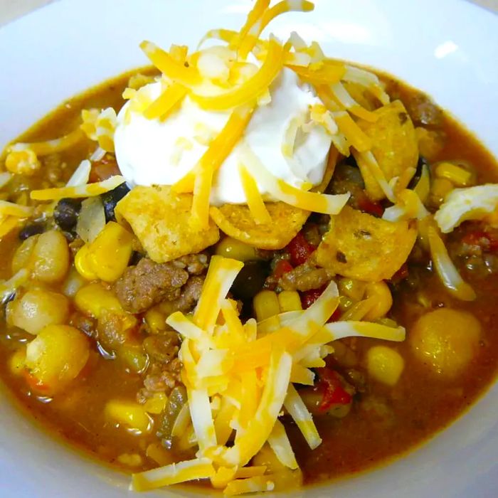 A hearty taco soup made with beans, sour cream, and melted Colby Jack cheese