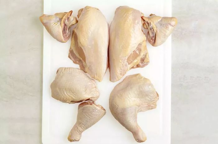 The whole chicken broken down into wings, breasts, thighs, and drumsticks