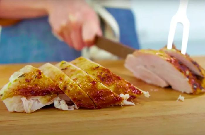 Sliced turkey breast resting on a cutting board.