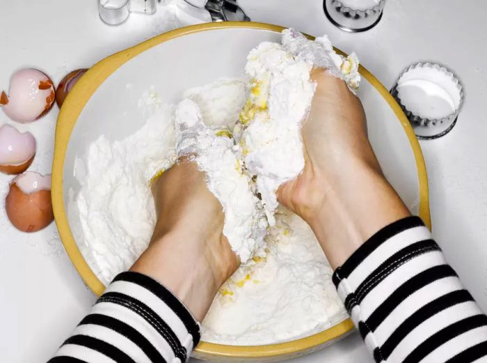 Woman mixing flour and eggs by hand