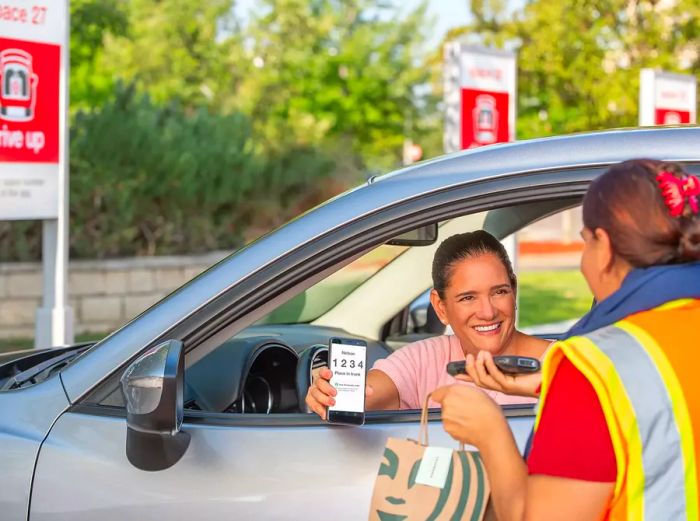 A Target customer receiving a Starbucks delivery straight to their car