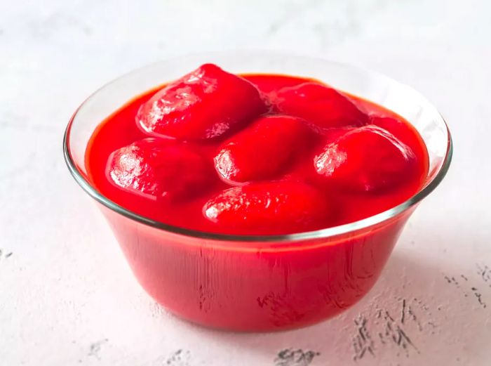 A bowl of canned San Marzano tomatoes on a table