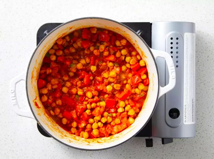 Chickpeas and tomato sauce have been added and mixed in.