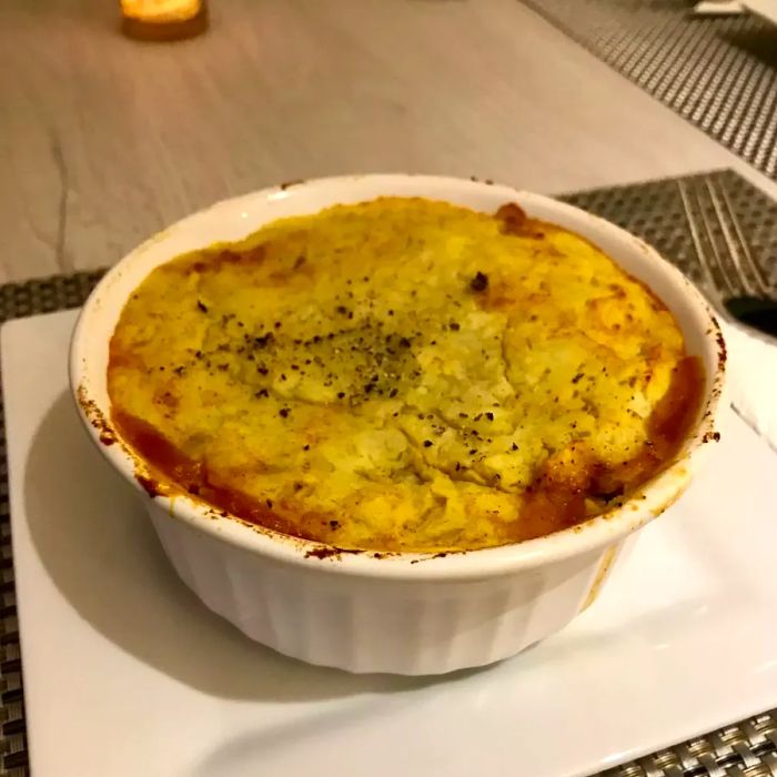 Moroccan Shepherd's Pie served in a white dish.