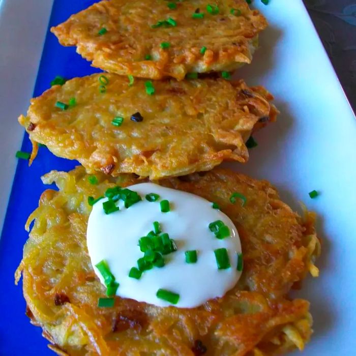 Crispy Potato Latkes I served with green onions and sour cream