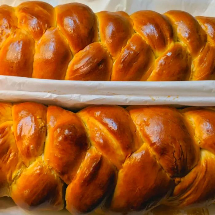 Two freshly baked challah loaves