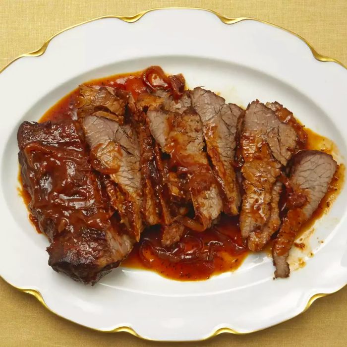 Beef brisket served on a white plate