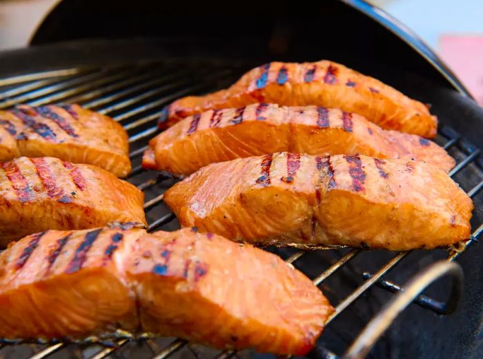 A grill with salmon fillets cooked to perfection.