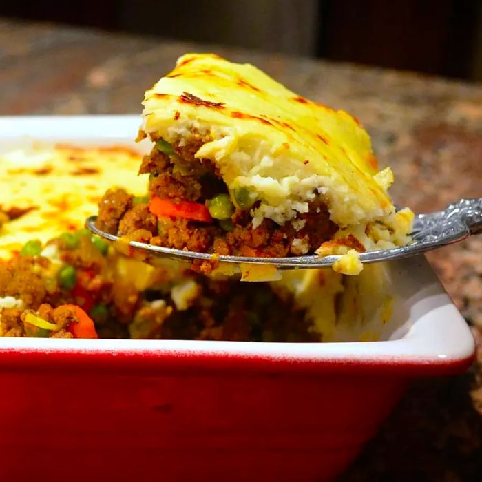 Paleo Shepherd's Pie served in a red casserole dish.