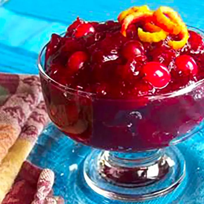 A close-up shot of a dish filled with rich brown sugar and port cranberry sauce