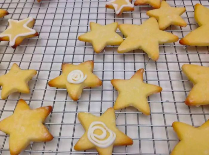 Star-shaped cut-out cookies cooling on a rack