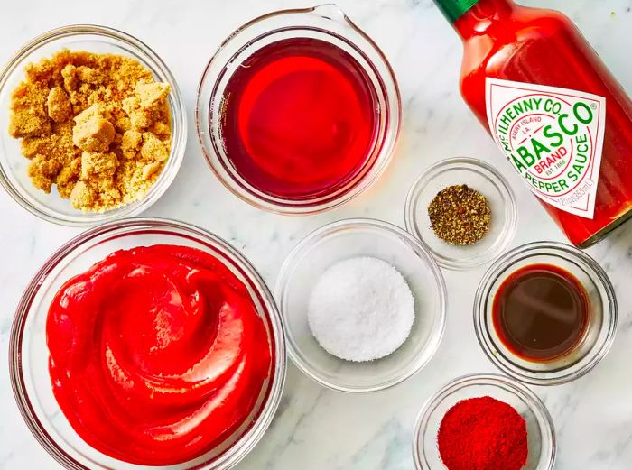 An overhead shot of BBQ sauce ingredients neatly arranged in small bowls.