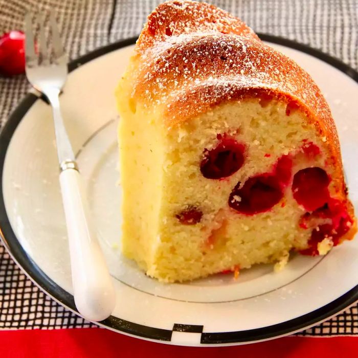 A slice of moist bundt cake served on a white plate