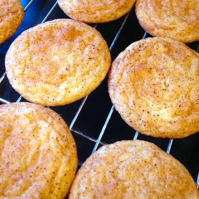 snickerdoodle cookies cooling on a baking rack