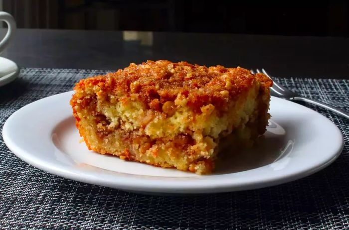 A slice of apple crumble coffee cake served on a plate