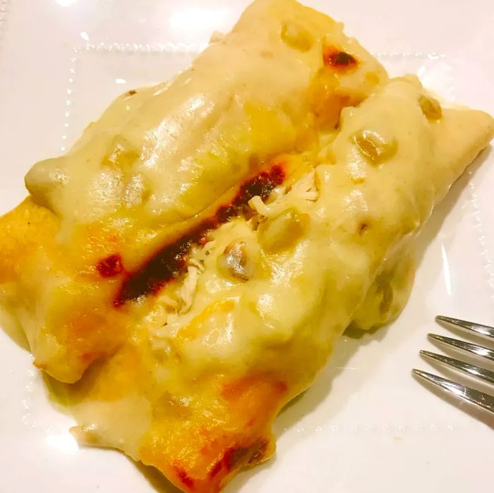 Chicken enchiladas with a rich, creamy white sauce