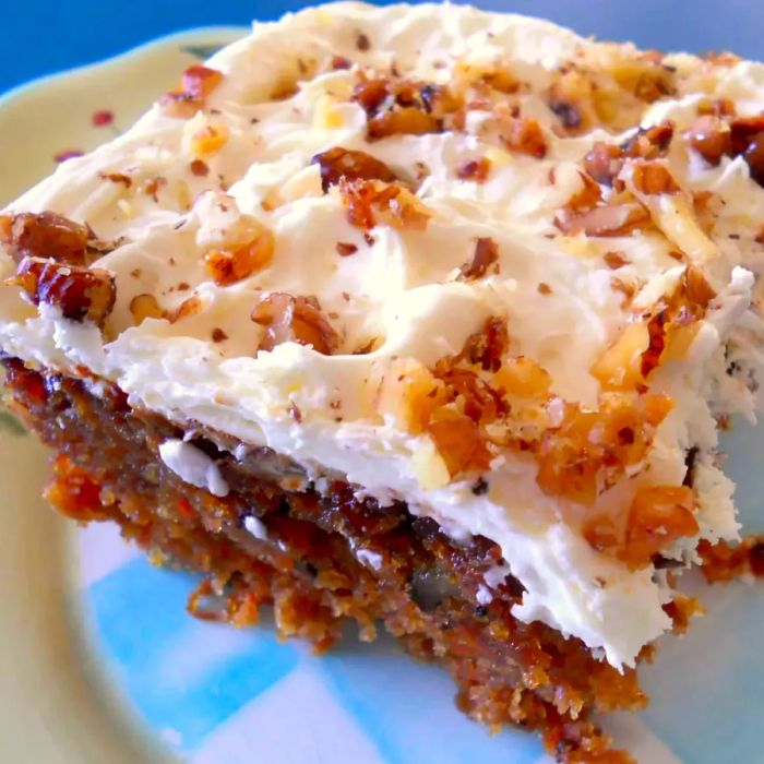 A slice of moist carrot cake on a plate