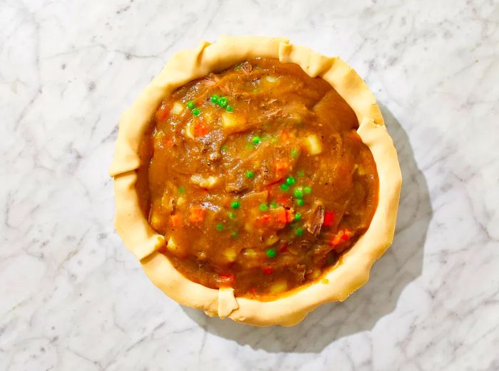 Beef mixture placed in the pie crust, followed by the gravy poured over the top.