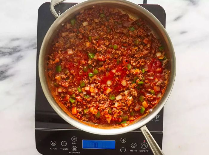 Ground beef sautéing with onions and green peppers