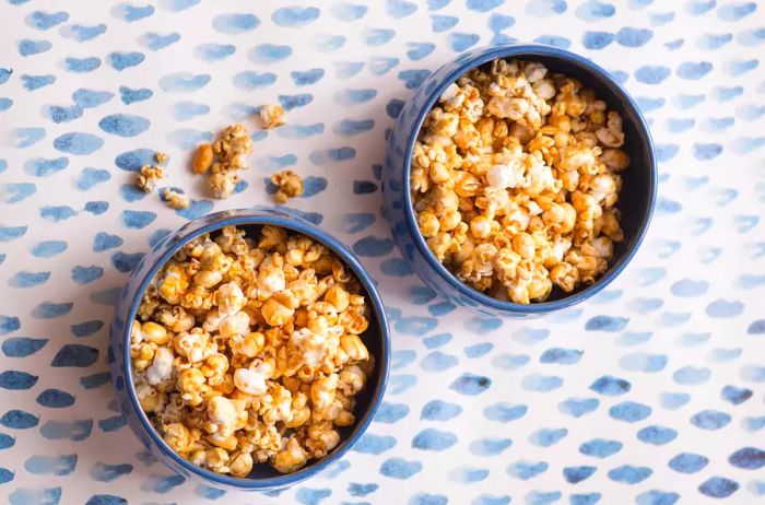 Sweet Popcorn in Bowls on a Blue Patterned Background