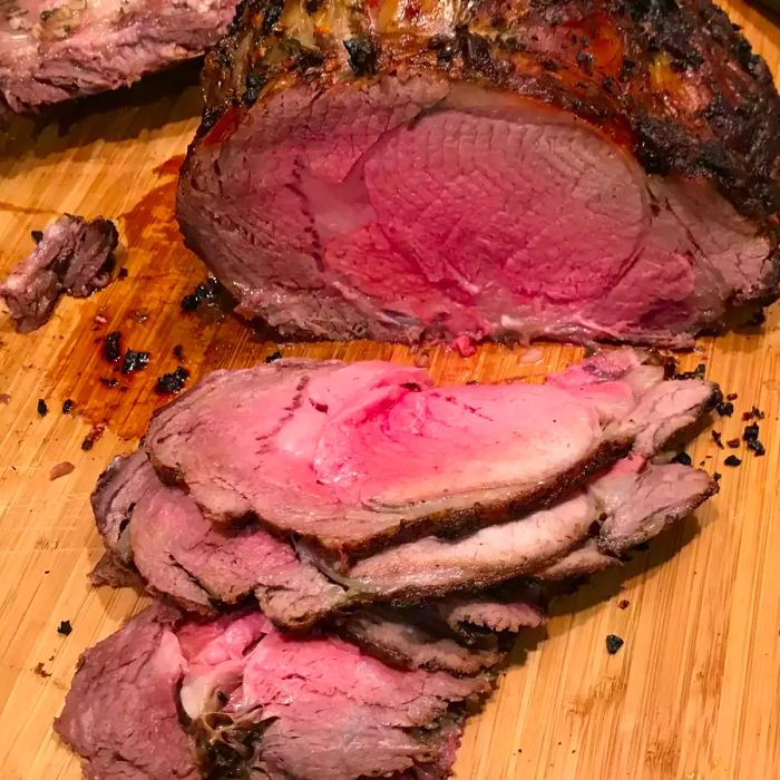 sliced prime rib served on a wooden carving board