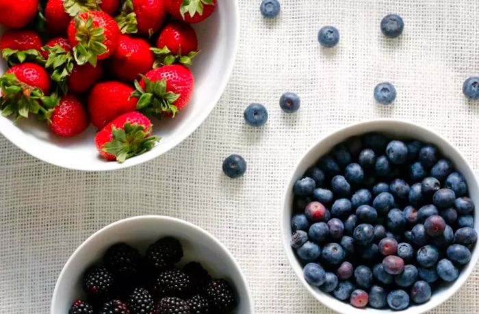 fresh strawberries, blueberries, and blackberries