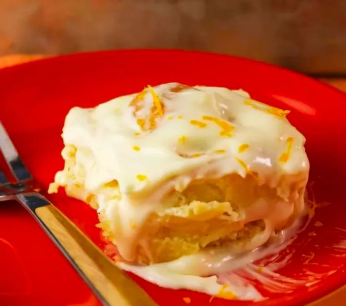 Grandma's fresh orange rolls topped with creamy orange cream cheese frosting