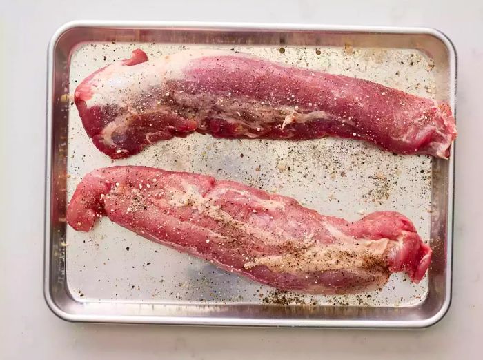 Tenderloins seasoned with garlic powder, salt, and pepper.