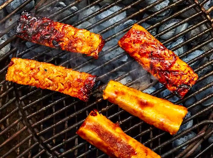 Cinnamon-sugar coated pineapple wedges caramelizing on the grill, giving off a delicious aroma.