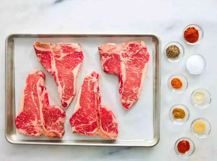 Rock's T-Bone Steaks ingredients arranged on a marble countertop