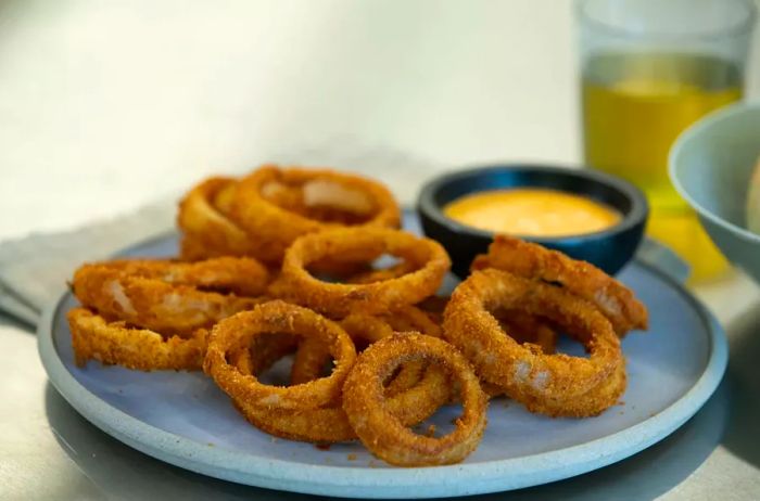 crispy onion rings served with dipping sauce