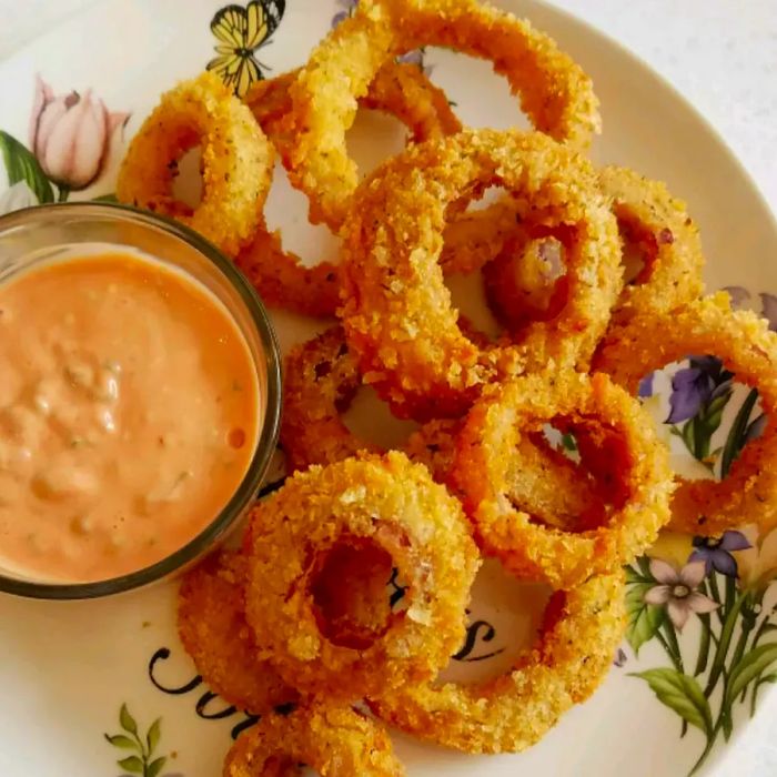 Homemade Classic Onion Rings paired with a rich, creamy dipping sauce