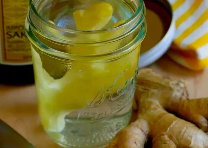 Fresh ginger stored in a jar with alcohol.