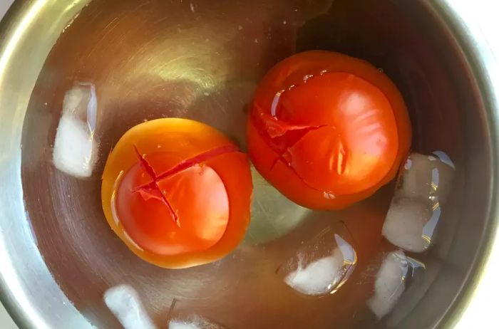 two tomatoes in an ice bath