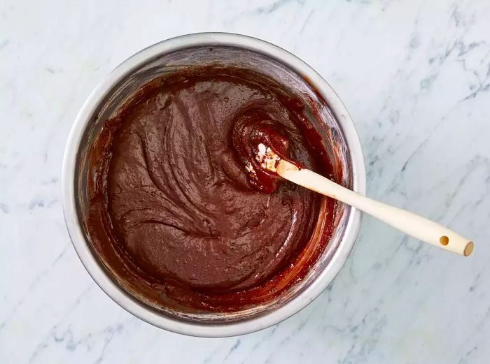 An aerial view showing the wet and dry ingredients mixed together in a medium bowl.