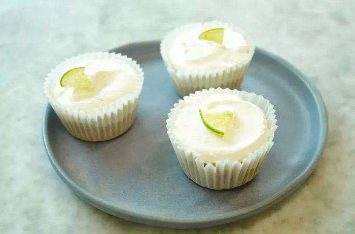 Three individual No-Bake Key Lime Pies arranged on a plate.