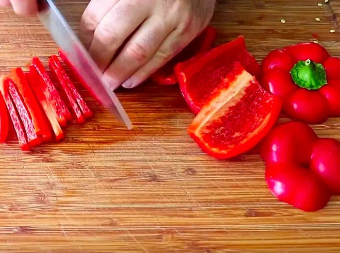 Chef John cutting a bell pepper into strips.