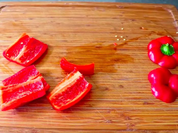 Four slices of bell pepper with the top and bottom pieces set aside.