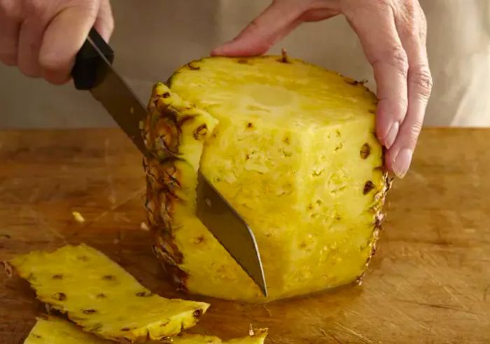 Cutting Away the Skin of a Pineapple