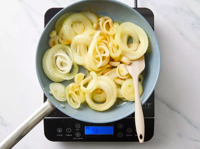 A large skillet with caramelized onion slices