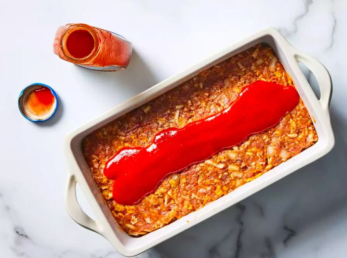 Mixture pressed into the loaf pan with taco sauce poured over the top