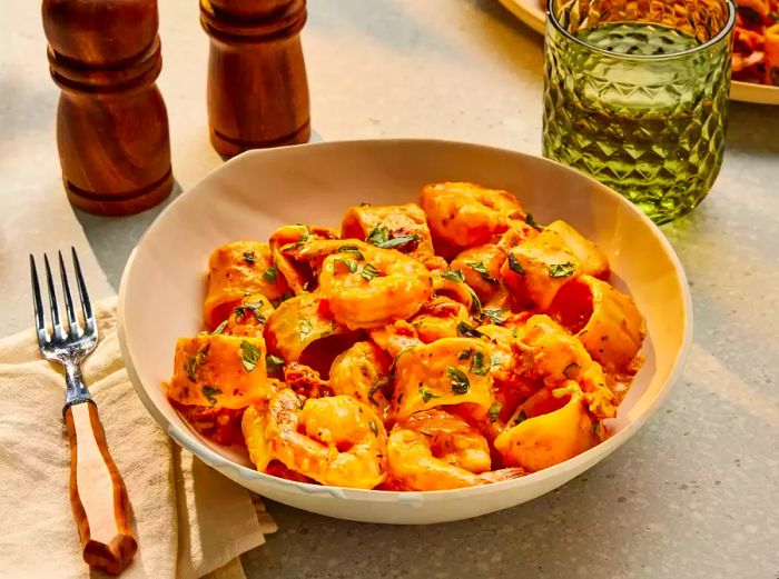 Marry Me Shrimp Pasta served in a white bowl, garnished with basil