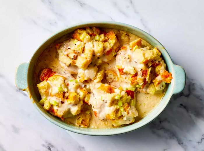 Baked stuffed pork chops with sauce, fresh from the oven in a baking dish.